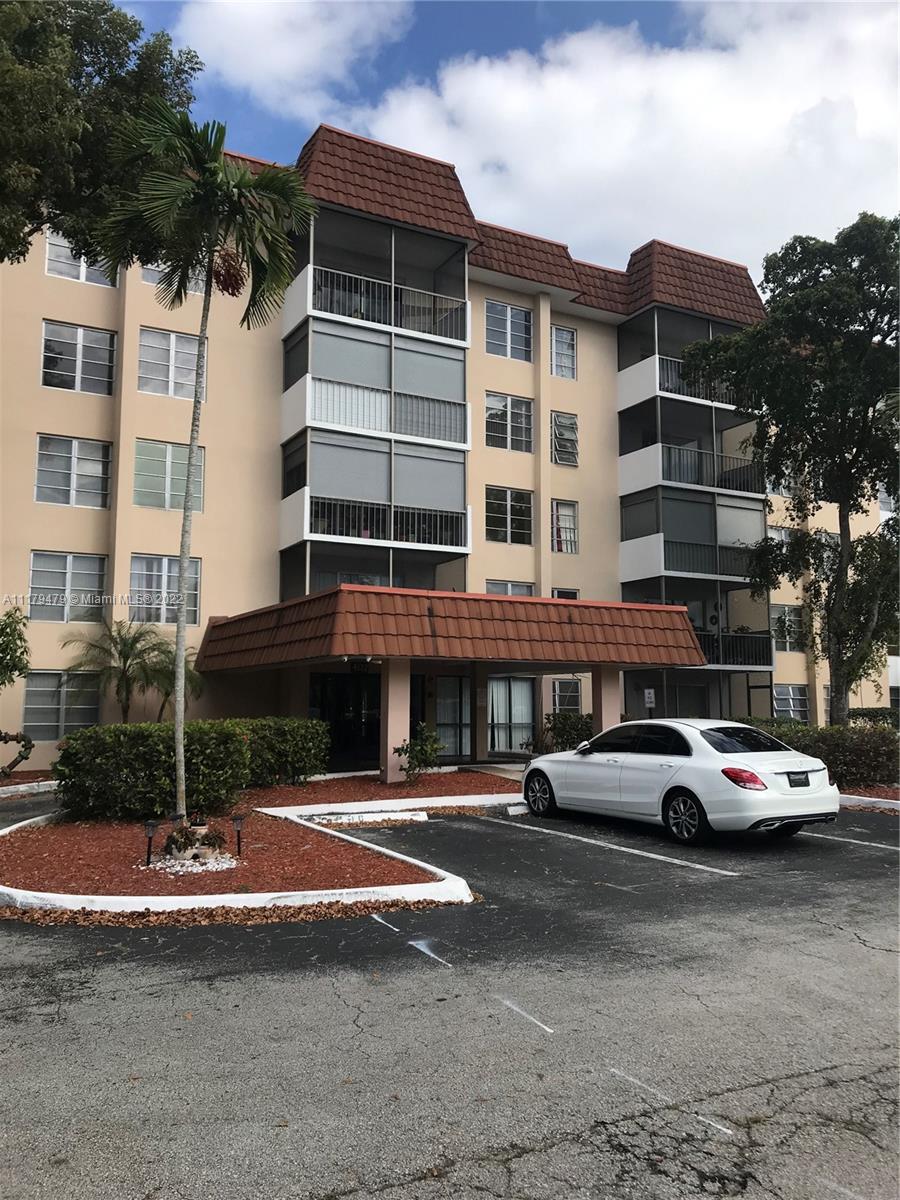 4172 Inverrary Drive, Unit 101 Lauderhill, FL 33319 - Photo 1 of 32 a front view of a residential apartment building with a yard