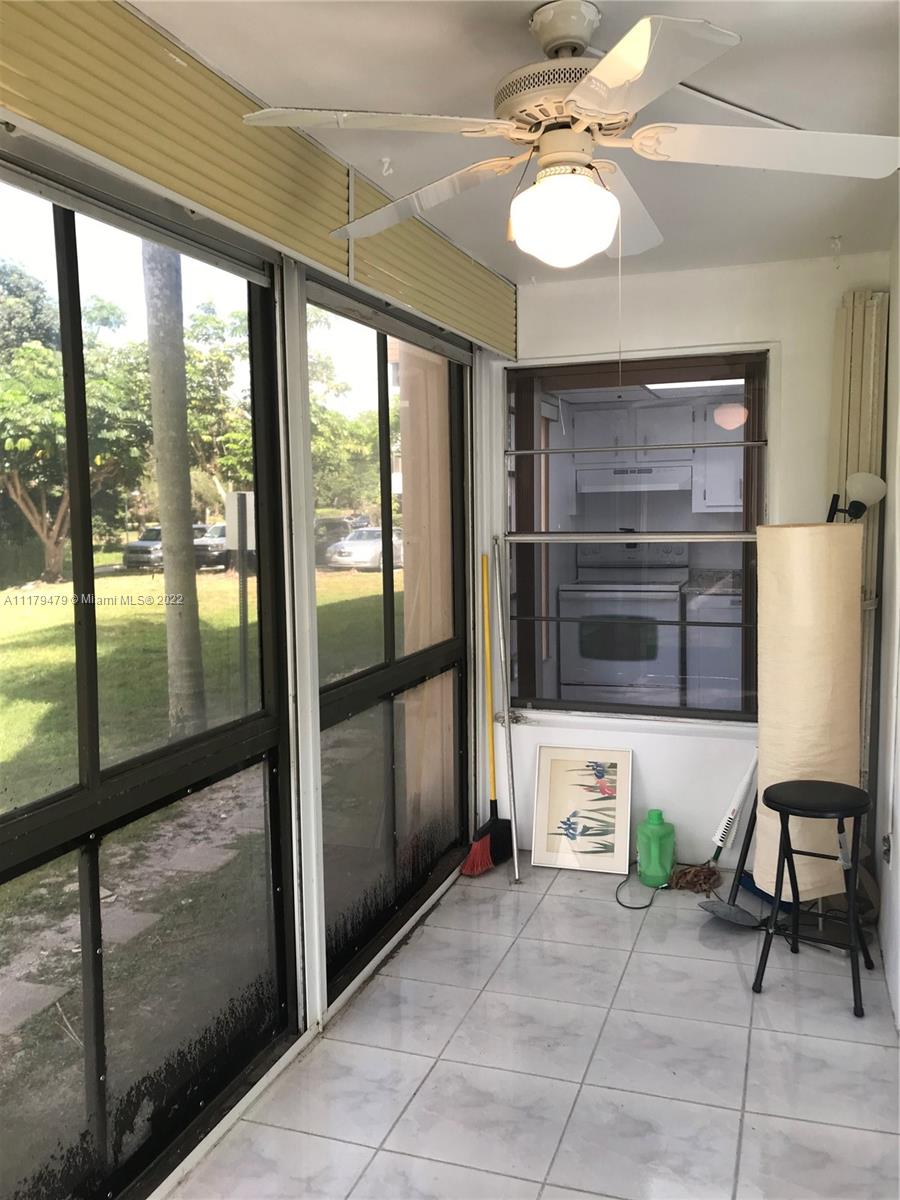 4172 Inverrary Drive, Unit 101 Lauderhill, FL 33319 - Photo 12 of 32 a living room with furniture a window and appliances