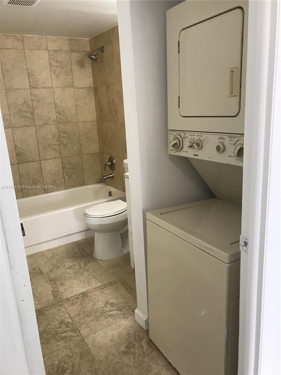 4172 Inverrary Drive, Unit 101 Lauderhill, FL 33319 - Photo 15 of 32 a bathroom with a toilet sink and tub