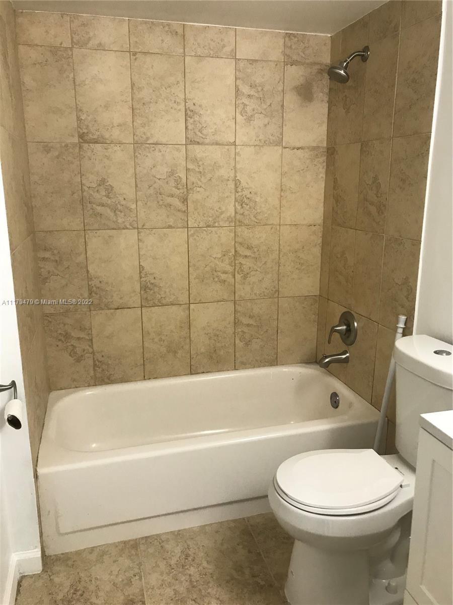 4172 Inverrary Drive, Unit 101 Lauderhill, FL 33319 - Photo 16 of 32 a bathroom with a toilet bathtub and shower