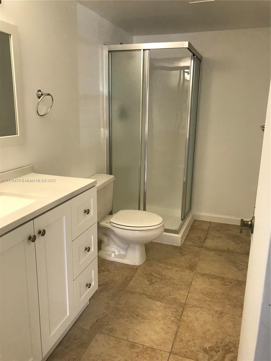 4172 Inverrary Drive, Unit 101 Lauderhill, FL 33319 - Photo 20 of 32 a bathroom with a granite countertop sink toilet and shower