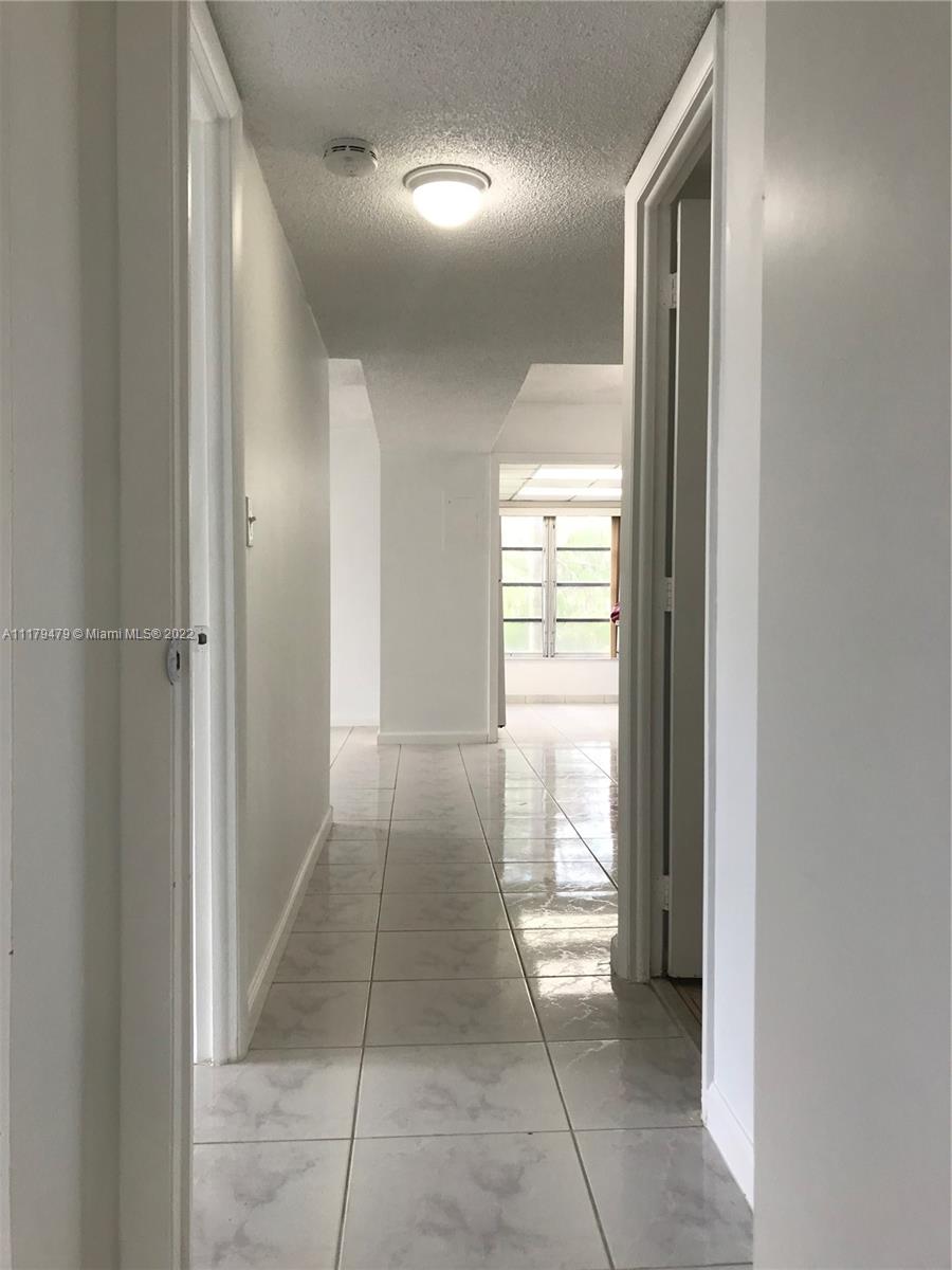 4172 Inverrary Drive, Unit 101 Lauderhill, FL 33319 - Photo 2 of 32 a view of a hallway and a livingroom with a window