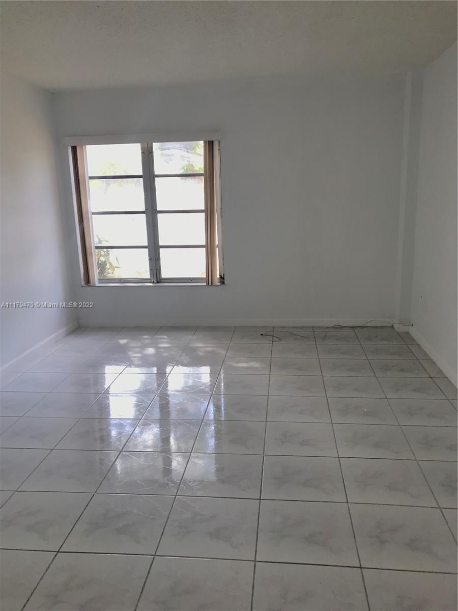 4172 Inverrary Drive, Unit 101 Lauderhill, FL 33319 - Photo 23 of 32 an empty room with windows