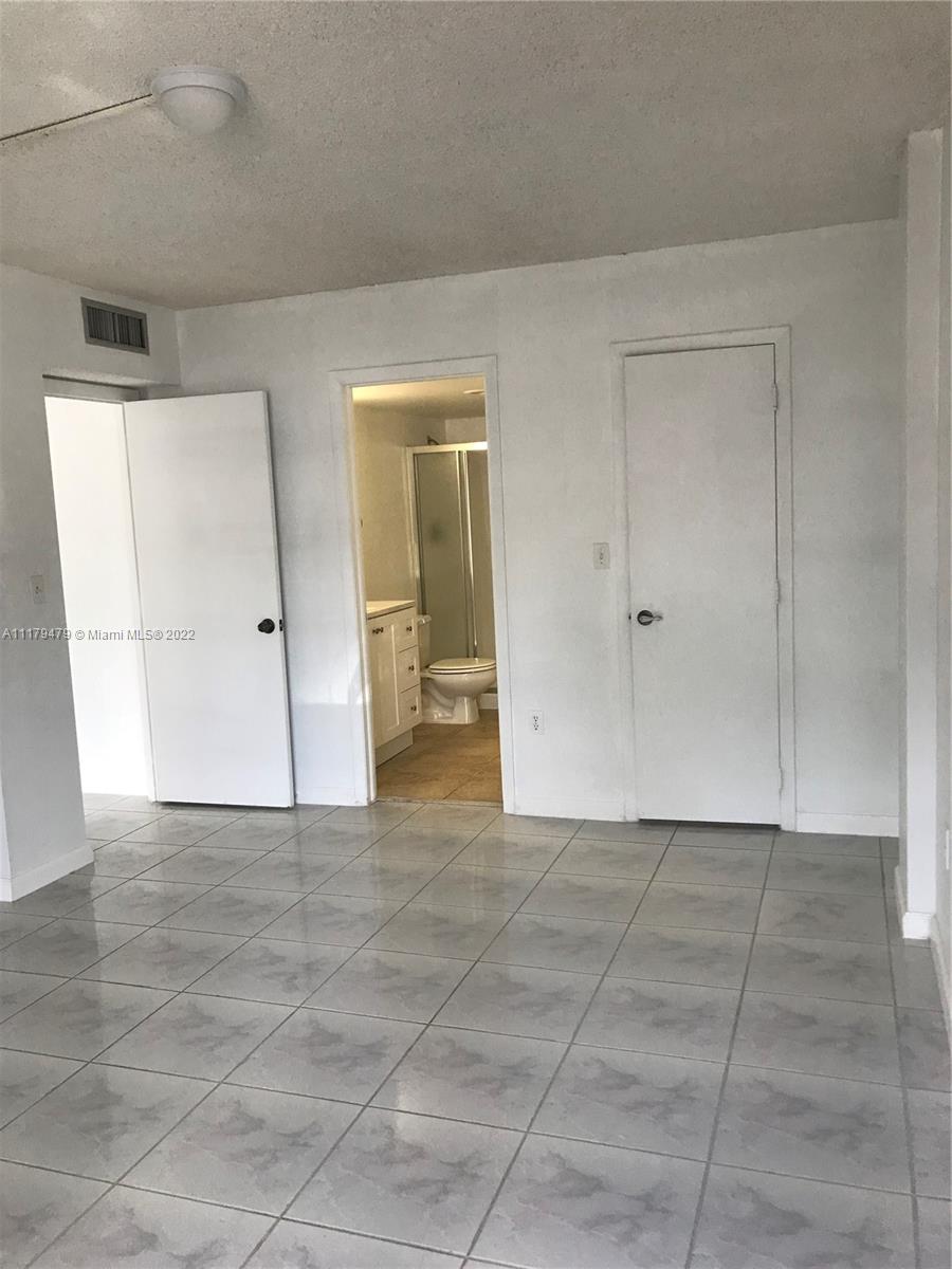 4172 Inverrary Drive, Unit 101 Lauderhill, FL 33319 - Photo 24 of 32 an empty room with a natural light and carpet