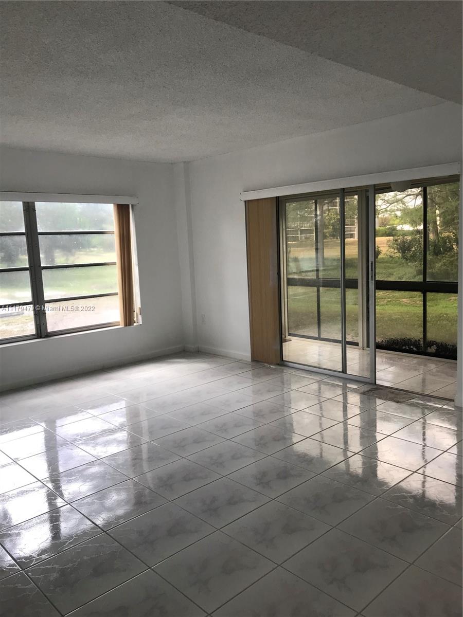 4172 Inverrary Drive, Unit 101 Lauderhill, FL 33319 - Photo 4 of 32 a view of an empty room with a window
