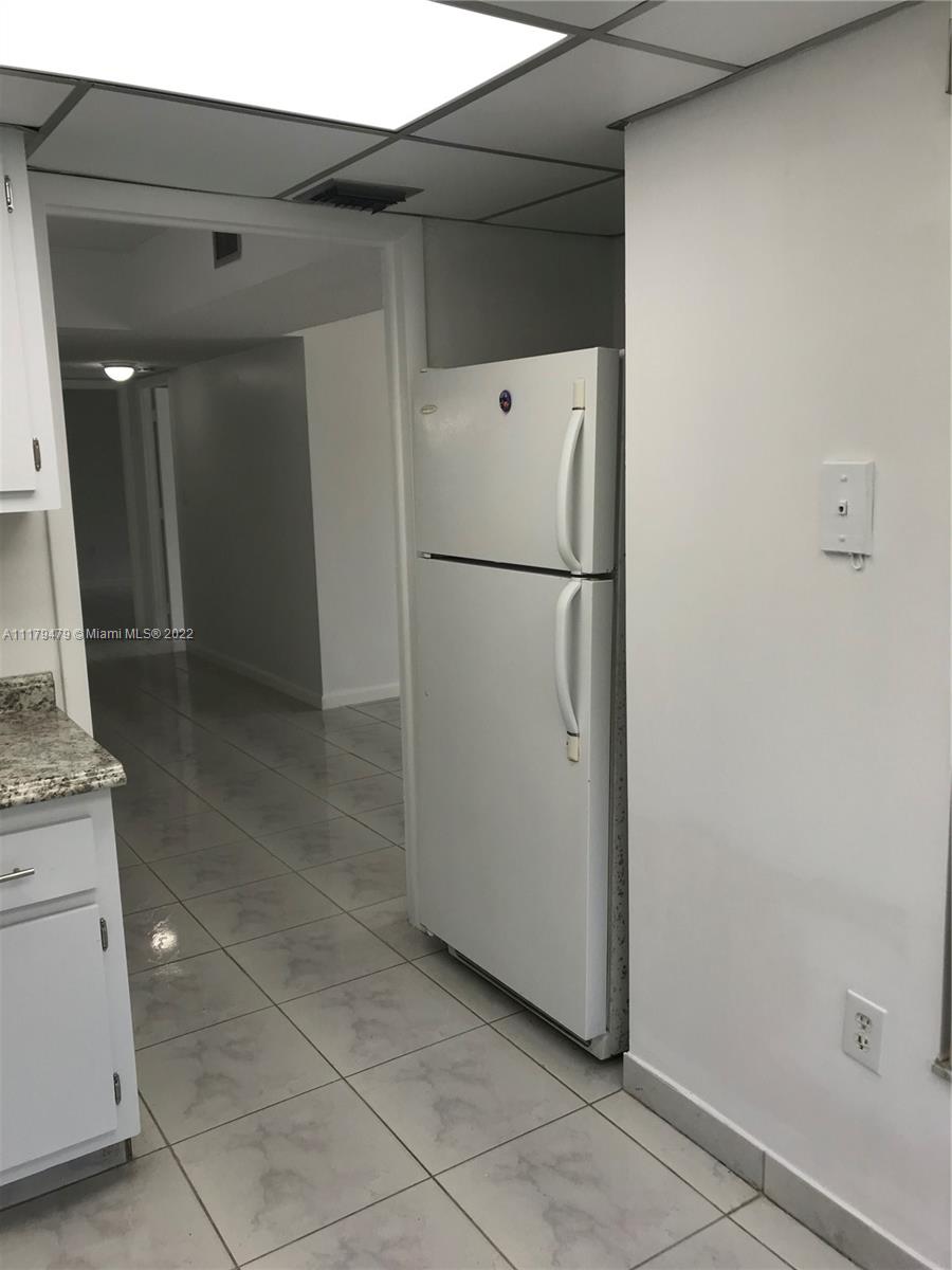 4172 Inverrary Drive, Unit 101 Lauderhill, FL 33319 - Photo 9 of 32 a view of kitchen with a sink refrigerator and cabinet
