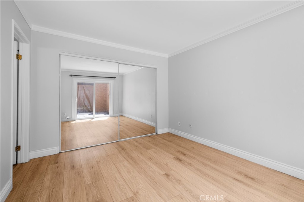2700 North Brea Boulevard, Unit 24 Fullerton, CA 92835 - Photo 13 of 27 a view of empty room with wooden floor and fan