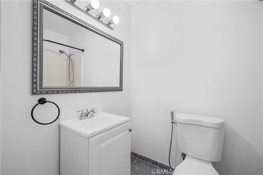 2700 North Brea Boulevard, Unit 24 Fullerton, CA 92835 - Photo 17 of 27 a bathroom with a sink a toilet and mirror