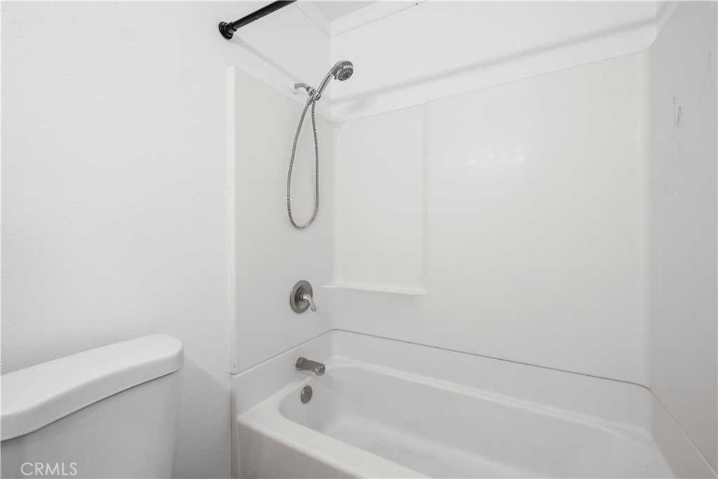 2700 North Brea Boulevard, Unit 24 Fullerton, CA 92835 - Photo 18 of 27 a bathroom with a bath tub and a shower