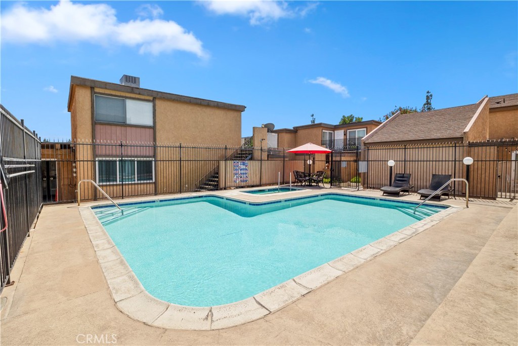 2700 North Brea Boulevard, Unit 24 Fullerton, CA 92835 - Photo 26 of 27 a view of a house with a swimming pool and a yard