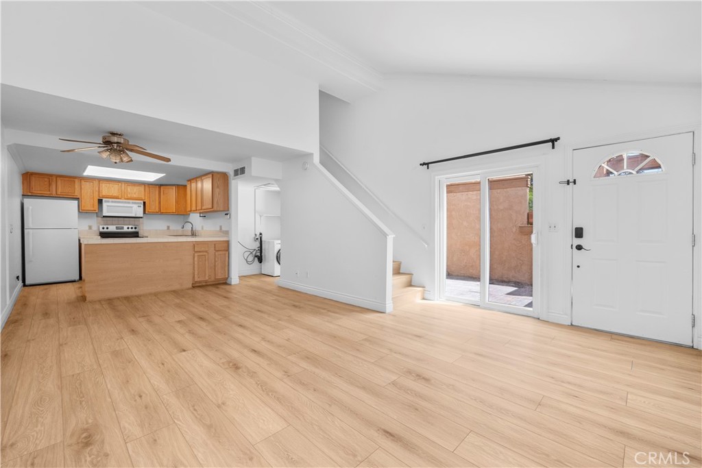 2700 North Brea Boulevard, Unit 24 Fullerton, CA 92835 - Photo 7 of 27 a view of a kitchen with a sink and a refrigerator