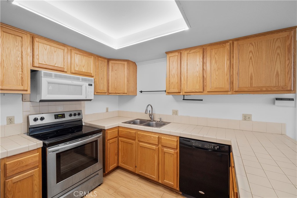 2700 North Brea Boulevard, Unit 24 Fullerton, CA 92835 - Photo 10 of 27 a kitchen with a sink stove top oven and cabinets