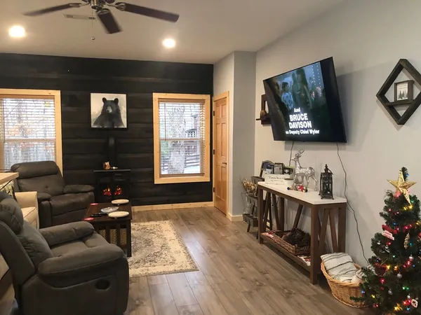 a living room with furniture a window and a flat screen tv