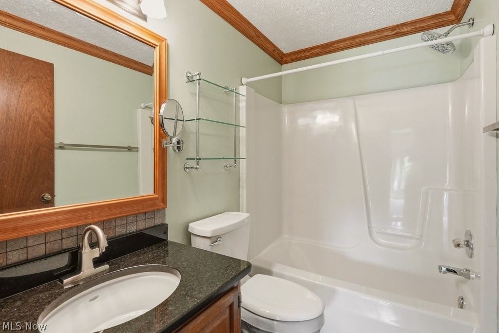 5321 Young Road Stow, OH 44224 - Photo 26 of 37 Bathroom featuring a dark granite-style countertop, undermount sink, and brushed nickel faucet