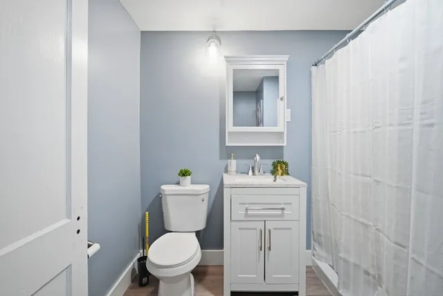 a white toilet sitting next to a bathroom sink