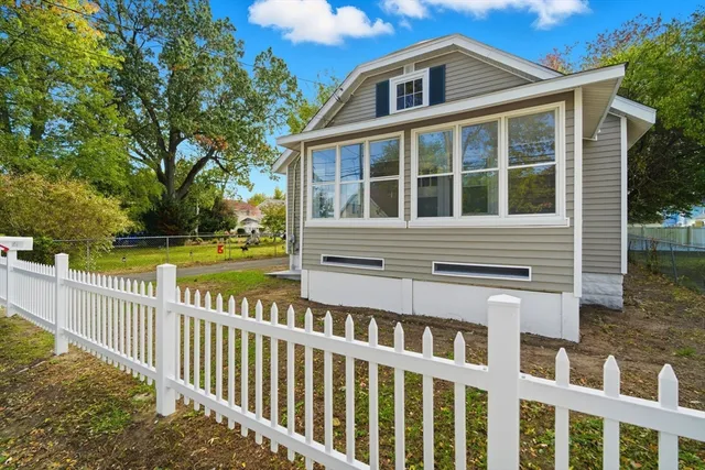 a front view of a house with a garden