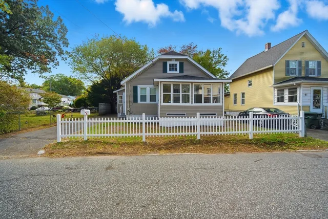 a view of a house with a big yard and fence