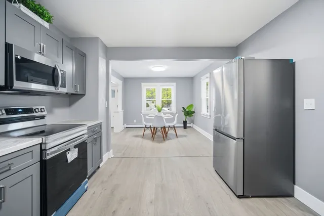 a kitchen with stainless steel appliances a refrigerator stove and microwave