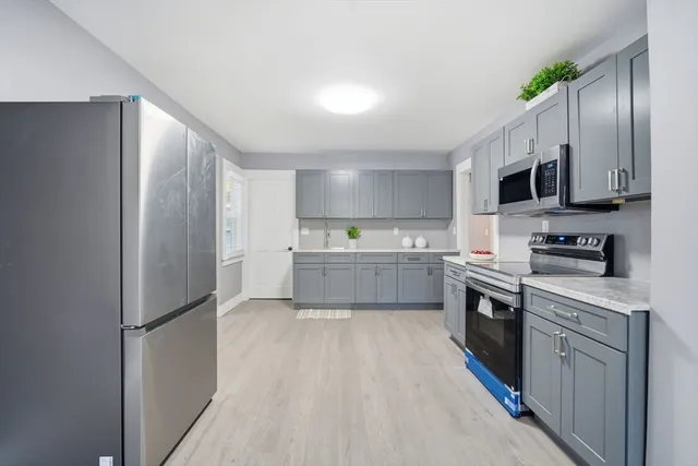 a kitchen with stainless steel appliances a refrigerator sink and microwave