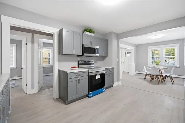 a kitchen with microwave a stove and cabinets