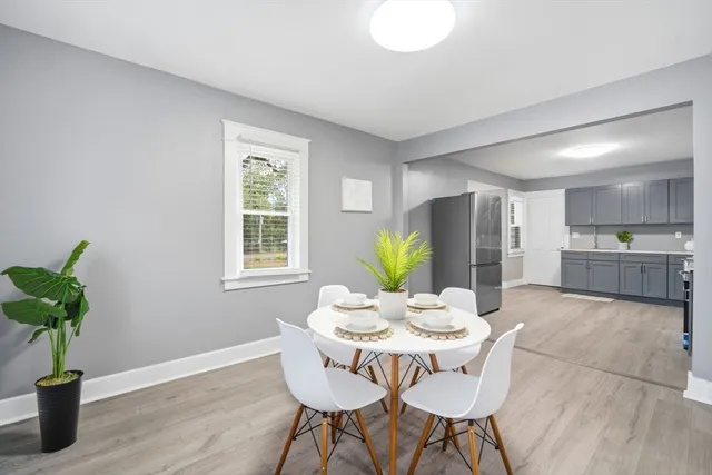 a view of a dining room with furniture and a potted plant