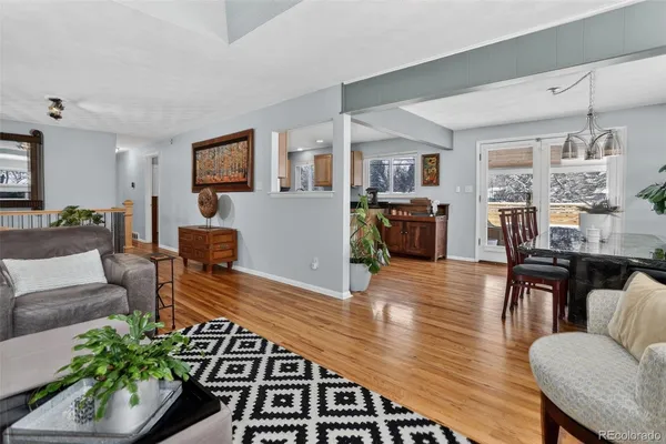 a view of a dining room with furniture wooden floor and a chandelier