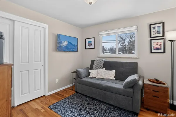 a living room with furniture and a lamp