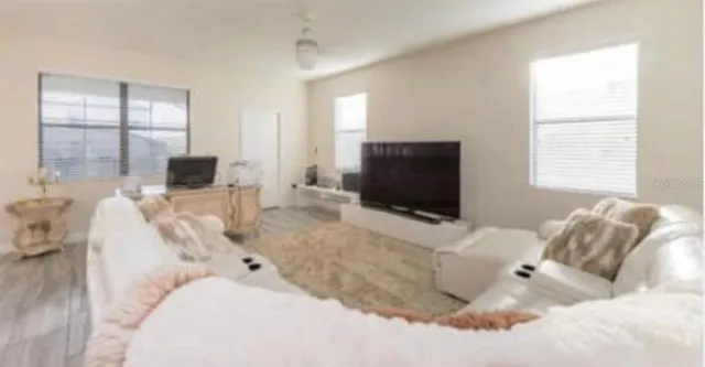 a living room with furniture and a flat screen tv