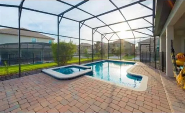 a view of swimming pool with a backyard