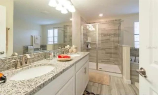 a bathroom with a granite countertop sink and a mirror