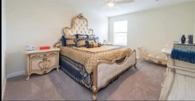 a bed sitting in a bedroom next to a window