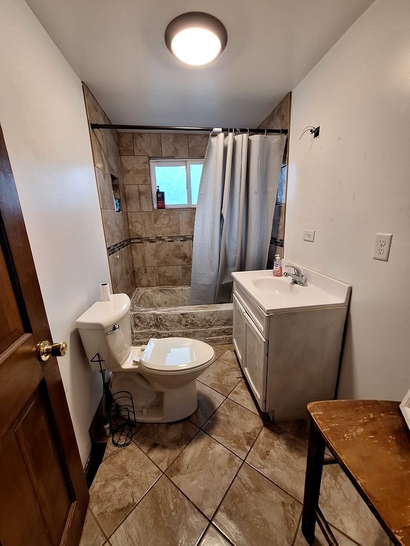 1505 North Otter Creek Road Streator, IL 61364 - Photo 9 of 40 a bathroom with a toilet sink and mirror
