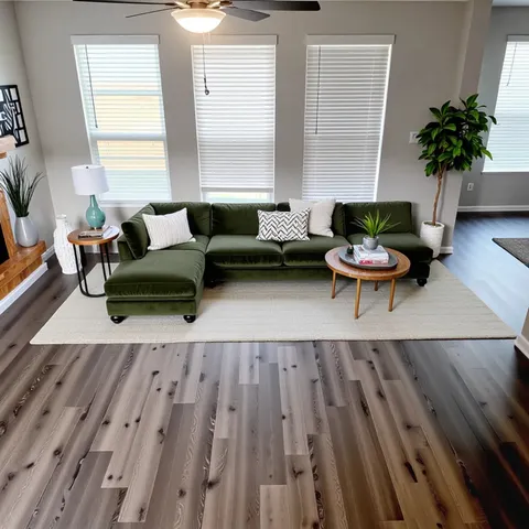 a living room with furniture and a potted plant
