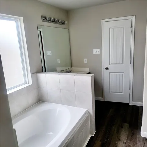 a bathroom with a bathtub and a sink