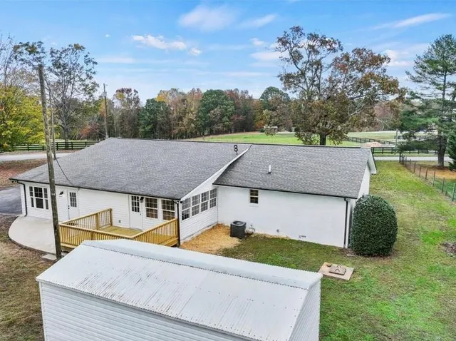 an aerial view of a house with a yard and lake view