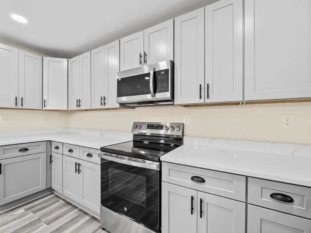 a kitchen with kitchen island a sink stainless steel appliances and cabinets
