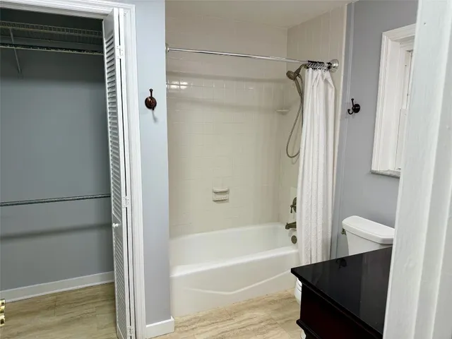a bathroom with a shower and a bath tub