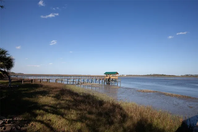 a view of a terrace with lawn chairs and iron fence