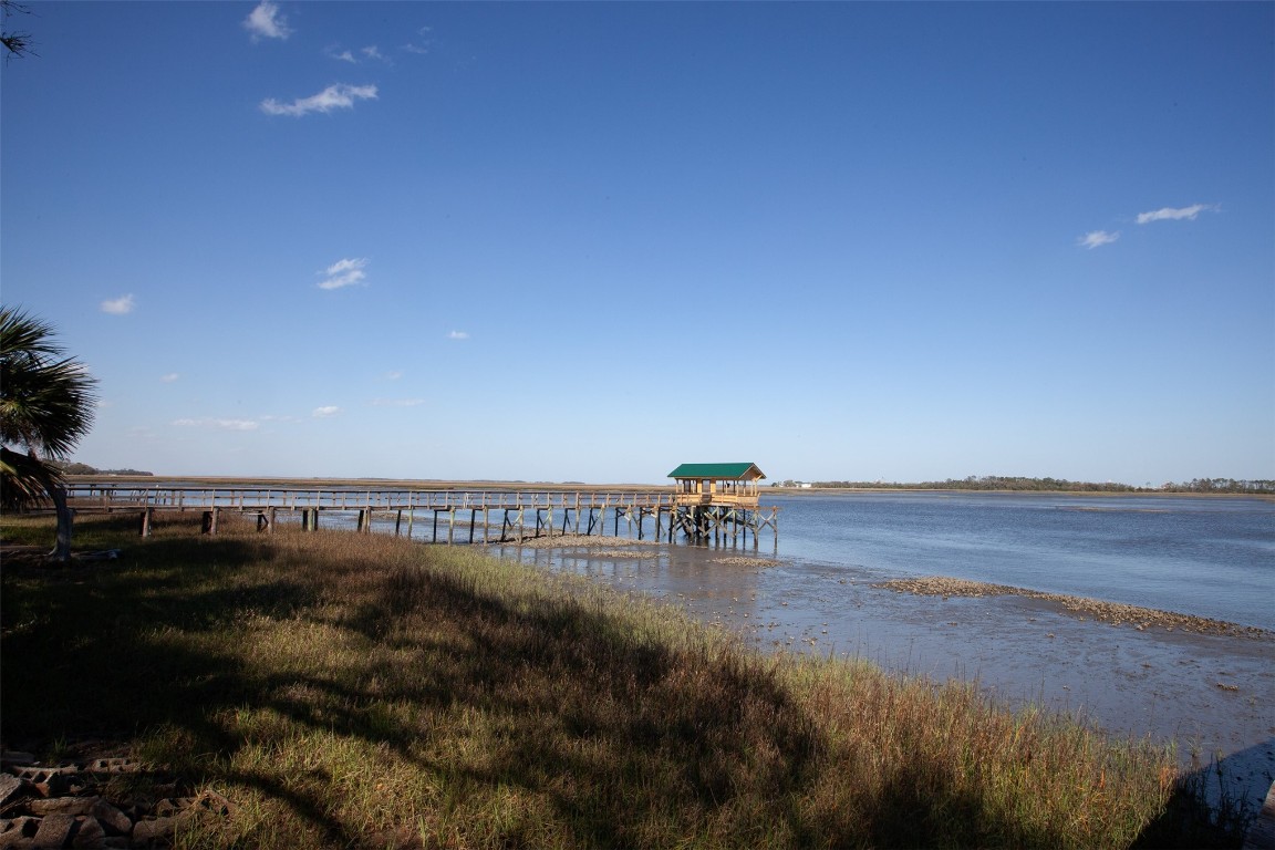 96153 Noeta Place Yulee, FL 32097 - Photo 16 of 24 a view of a terrace with lawn chairs and iron fence
