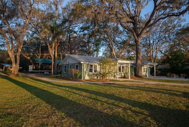 a front view of a building with trees
