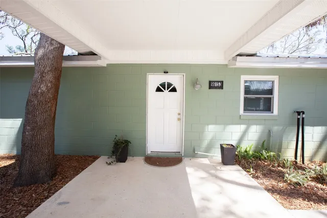 a bedroom with a bed and a potted plant