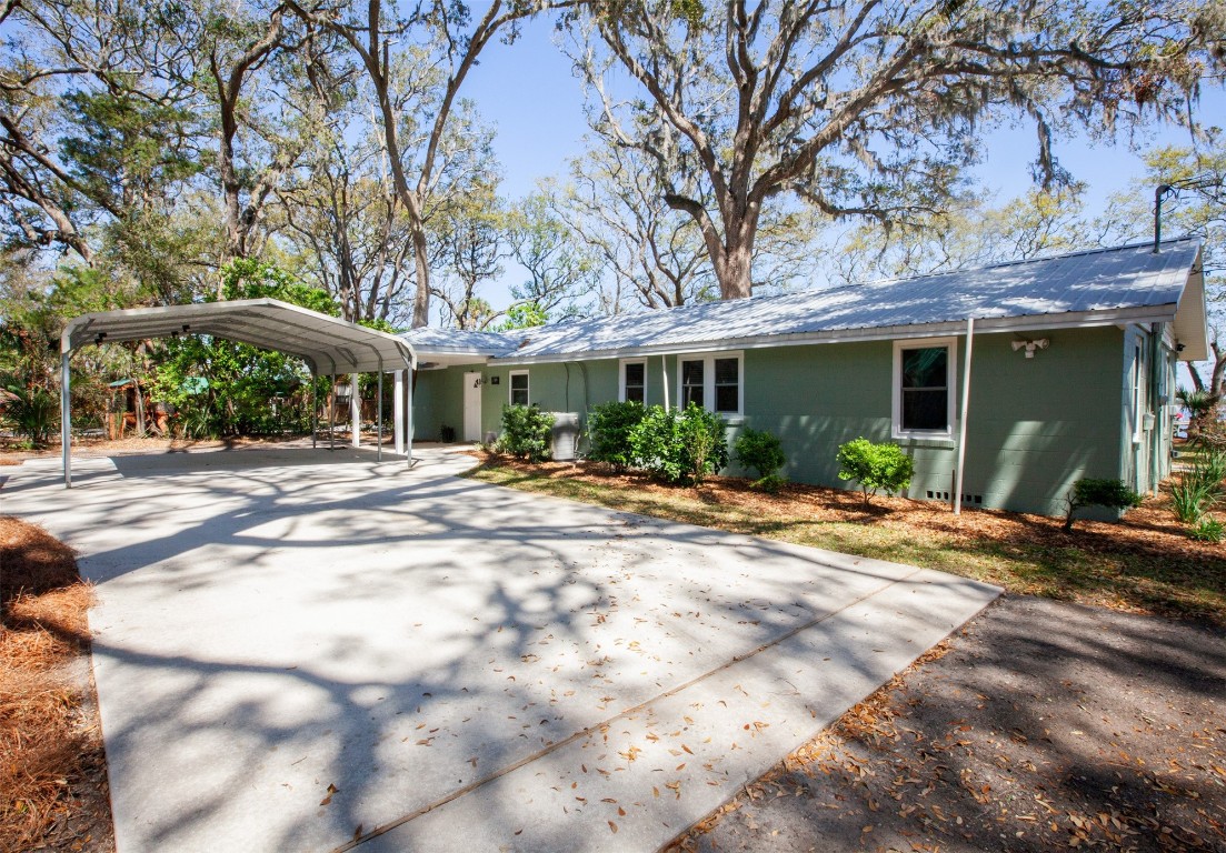 96153 Noeta Place Yulee, FL 32097 - Photo 5 of 24 a view of a white house with a large tree