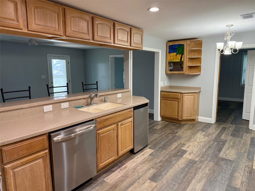 96153 Noeta Place Yulee, FL 32097 - Photo 8 of 24 a kitchen with stainless steel appliances granite countertop a sink and dishwasher a stove with wooden floors