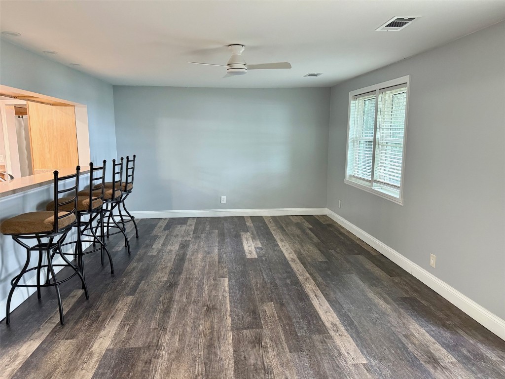 96153 Noeta Place Yulee, FL 32097 - Photo 10 of 24 an empty room with wooden floor and windows