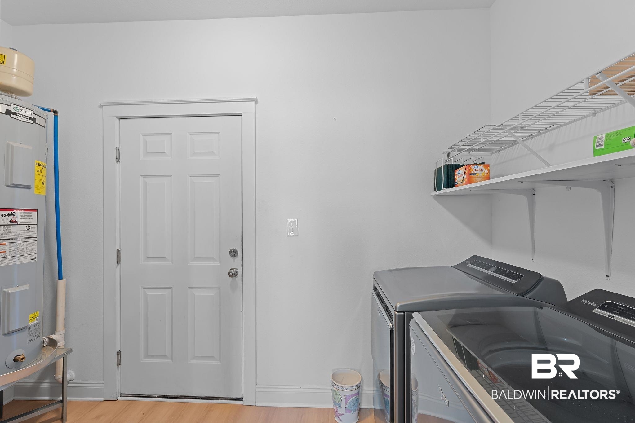 28980 Comstock Road Elberta, AL 36530 - Photo 21 of 38 Laundry area with light wood-style flooring, water heater, and washer and clothes dryer