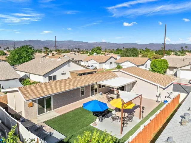 an aerial view of a house with a swimming pool