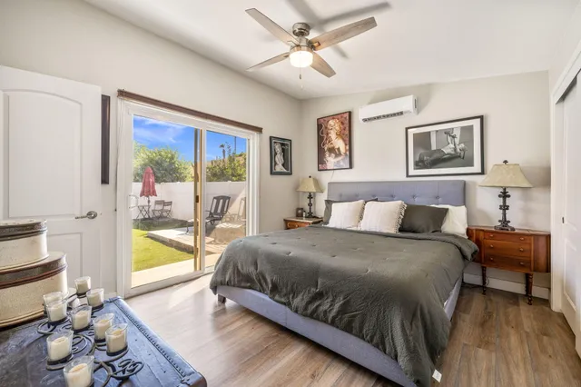 a living room with a bed furniture and a large window