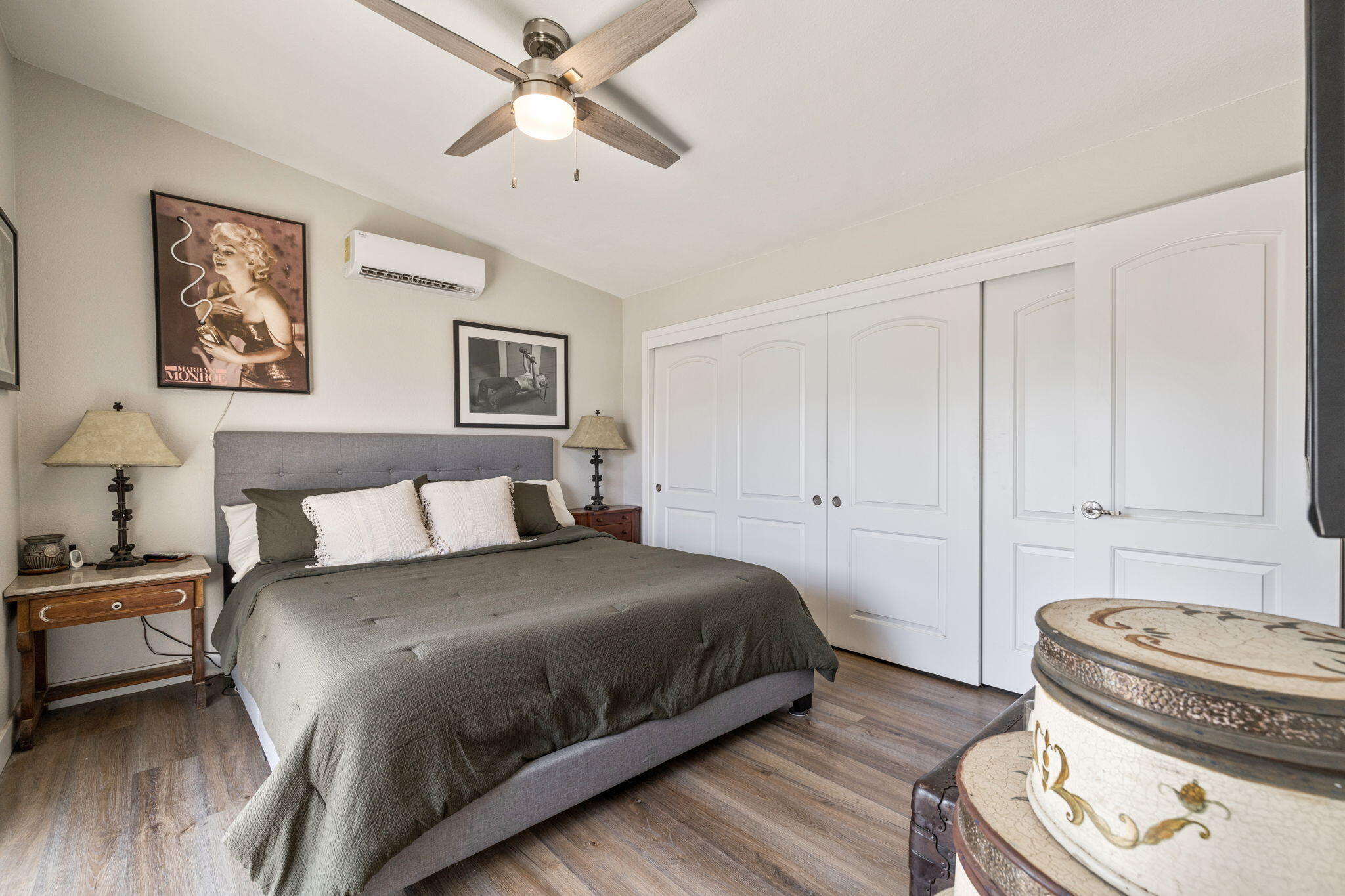 47800 Madison Street, Unit 79 Indio, CA 92201 - Photo 22 of 31 a bedroom with a bed and a chandelier