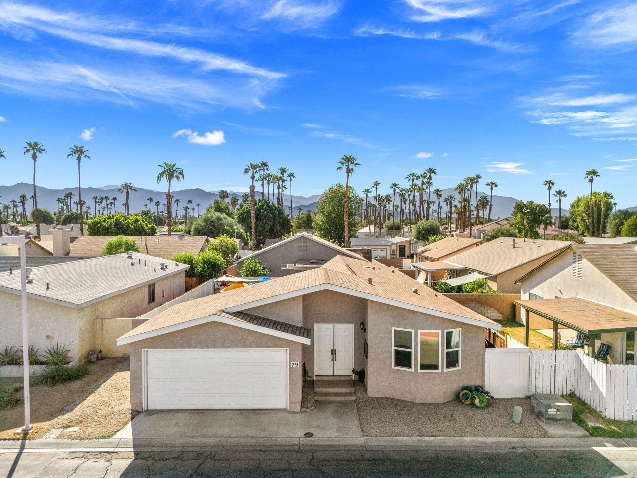 47800 Madison Street, Unit 79 Indio, CA 92201 - Photo 4 of 31 a view of a white house with a yard