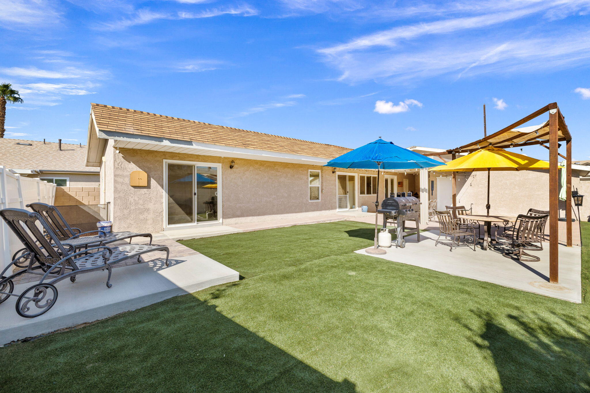 47800 Madison Street, Unit 79 Indio, CA 92201 - Photo 7 of 31 a patio with a table and chairs under an umbrella